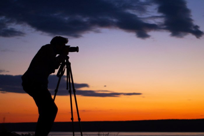 A photographer shooting a sunset