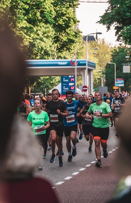 Marathon runners seen through the crowd